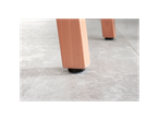 Close-up of light wood furniture legs with black protective floor glides on a light gray floor.