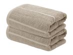 Two neatly folded beige towels stacked on top of each other.