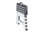 A folded, polka-dotted plastic step stool with a carrying handle.