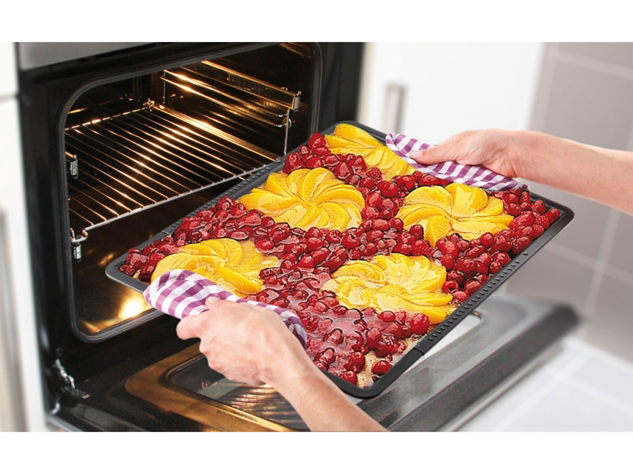 Een fruitcake wordt uit de oven gehaald.