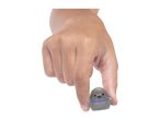 Hand holding a small, cute, grey toy with pink cheeks and a purple and green collar.