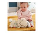 A baby in a pink top and striped pants playing with a soft bunny toy on a yellow blanket.