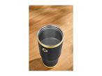 Black and gold insulated tumbler with water on a wooden surface.