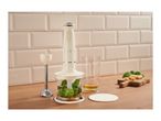 Retro-style hand blender set with chopper, beaker, and blending attachment on a wooden countertop