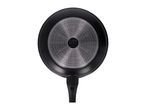 Bottom of a black frying pan with a textured silver base and a black handle.