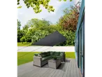 Garden shade sail, wicker sofa and coffee table on a deck.