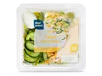 Een Caesar saladeschotel met Romeinse sla, komkommer, ei, kaas en croutons in een plastic verpakking.