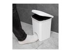 Person's foot opening a white pedal bin with a textured surface.