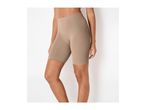 Woman wearing seamless beige cycling shorts, side view.