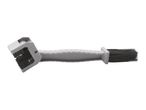 A grey plastic cleaning brush with two different bristle heads.