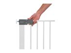 A hand operating the latch of a white child safety gate.