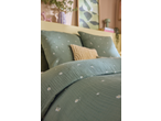 Livarno Premium Muslin Duvet Cover Set in sage green with daisy print, on a bed.