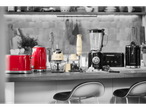 Kitchen counter with red toaster and kettle, cream blender, and black blender.