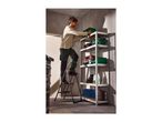 Man on a stepladder organizing green storage boxes on a metal shelving unit in a garage.