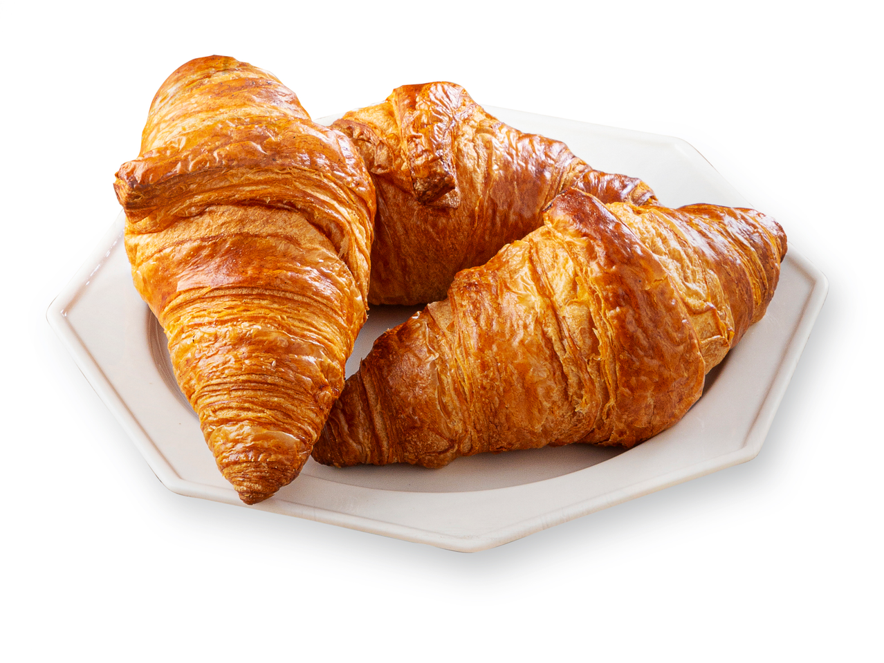 Três croissants crocantes em um prato branco.