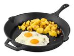 Fried potatoes with bacon and two fried eggs in a black cast iron pan.