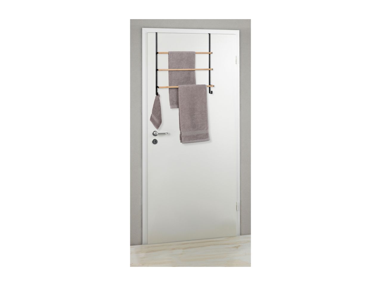 Over-the-door towel rack with three wooden bars and a hook, holding three grey towels.
