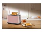 A pink SilverCrest toaster with two slices of toast, jam, and a knife on a wooden table.
