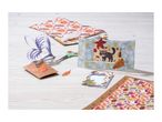 Craft supplies including patterned paper, scissors, glue, and partially assembled cards.