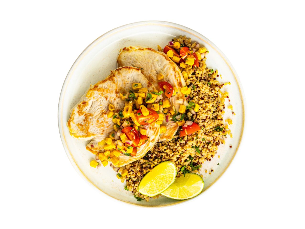 Grilled turkey breast served over quinoa with corn salsa and lime wedges.