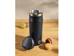 Termo preto com detalhes dourados e macarons coloridos sobre uma mesa de madeira.