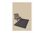 Wooden chair with grey cushions and a black and white patterned rug on a beige background.