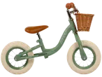 Green Huffy balance bike with wicker basket.