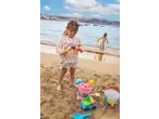 Lupilu Sand Toys: girl playing with ice cream cone toy and other sand toys on beach.