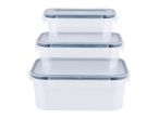 A set of three stackable plastic food storage containers with gray lids.
