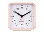 A pale pink square alarm clock with black hands and a white face.