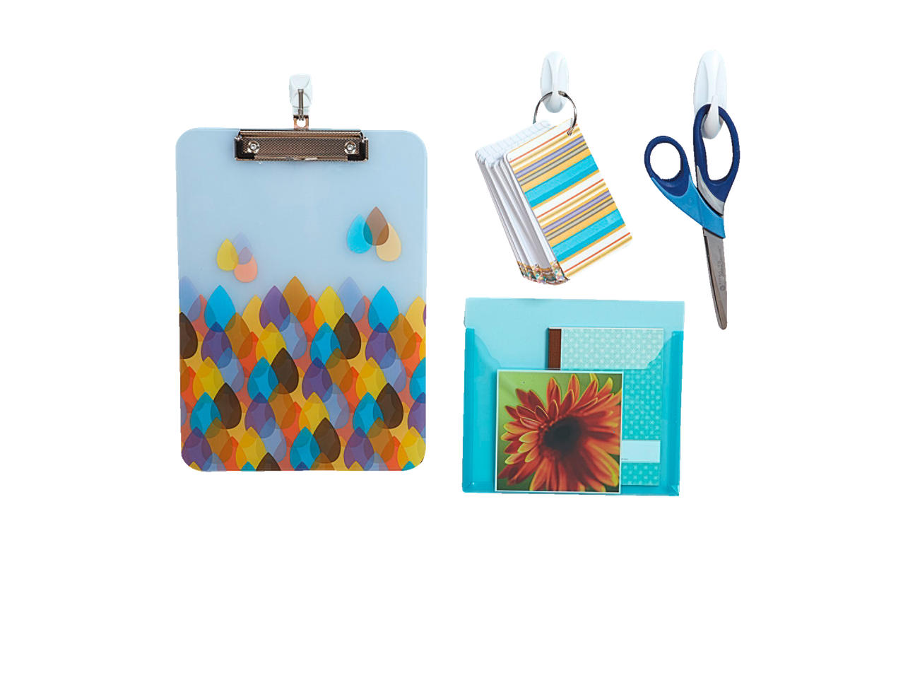 Clipboard, folder, scissors, and document holder hanging on adhesive hooks.