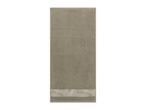 A beige towel with a decorative band featuring a subtle leaf pattern at the bottom.