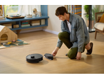 ROBOROCK Saug- und Wischroboter: man interacteert met een robotstofzuiger en dweil op een houten vloer.