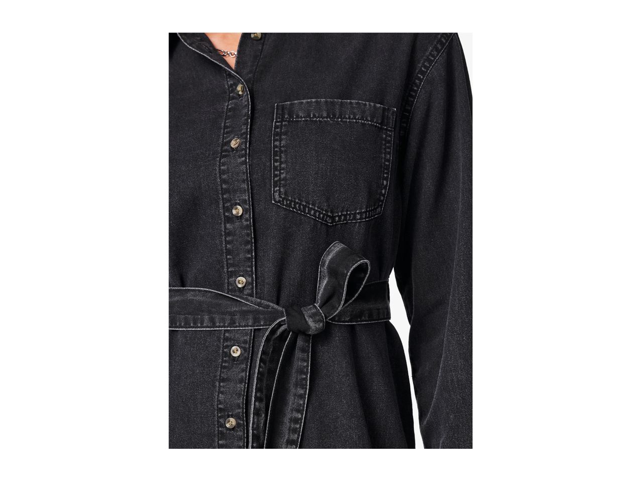 Close-up of a black denim shirt dress with a tied belt
