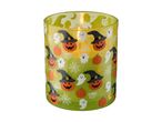 Halloween-themed candle in a green glass holder with pumpkins, ghosts, and spiderwebs.