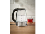SILVERCREST® Colour Changing Glass Kettle with water, next to a cup of tea.