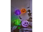 Halloween lanterns and skeleton decoration on a wooden surface with cobwebs.