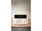 A cream-colored SILVERCREST® 2600W Dual Basket Air Fryer on a wooden countertop.