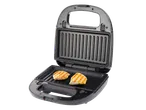 Bucăți de carne la grătar pe un grătar electric.