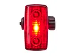Red bicycle taillight with a bright yellow light in the center.