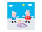 Three pig figures, two standing and one lying down, against a blue sky with clouds and sun.