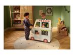 Two children playing with a toy food truck in a Christmas-decorated room.