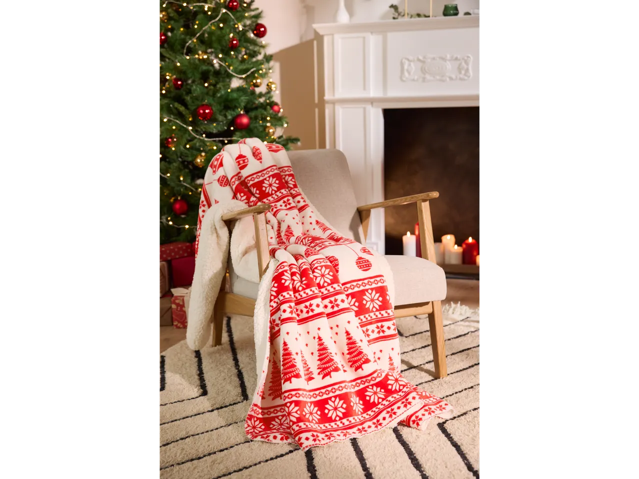 LIVARNO home Blanket with red and white Christmas pattern on a chair in a festive room.