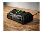 A Parkside X20V Team battery charger with two batteries charging on a wooden surface.