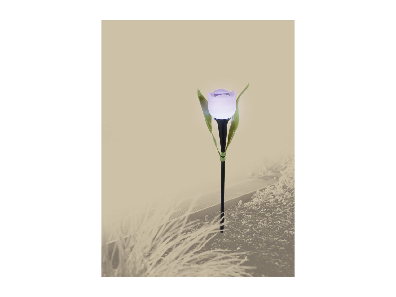 A solar-powered tulip-shaped garden light with green leaves, illuminating a garden bed.