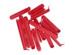 A pile of red plastic bag clips with textured surfaces.