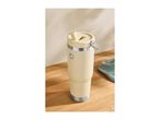 Cream-colored insulated tumbler with a straw lid and a metal handle on a wooden surface.