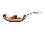 Copper frying pan with stainless steel interior containing cooked meat and herbs