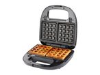 Open waffle maker with two golden-brown waffles inside, ready to eat.