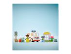 Toy ambulance, two figures, and building blocks on a light blue background.
